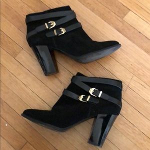 Black ankle heeled booties with gold buckle decor
